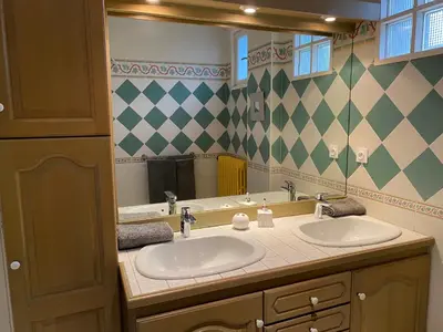 a bathroom with two sinks and a large mirror at MAISON MIGNARDISE - Cité in Carcassonne