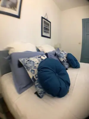 a couch with two pillows on top of it at L'affable Les cammazes in Les Cammazes