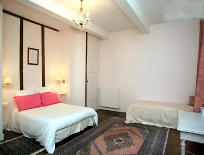 a bedroom with two beds with red pillows in it at L'affable Les cammazes in Les Cammazes