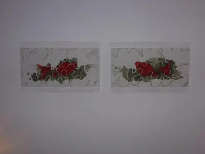 two stained glass windows with red roses on a wall at Chambre d'Hôtes la Poterie in Caunes-Minervois