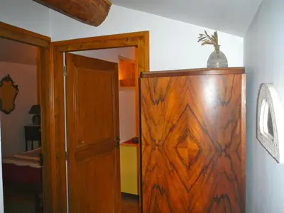 a room with a wooden cabinet and a door at Gite Le Lavoir - La Poterie in Caunes-Minervois
