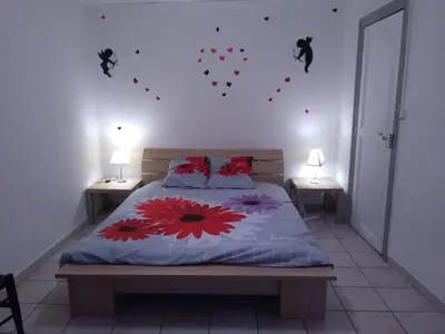 a bedroom with a bed with hearts on the wall at Le Minervois in Carcassonne
