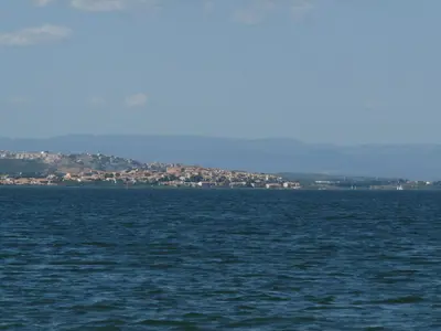 a large body of water with a city in the background at appartement de la callade in Peyriac-de-Mer