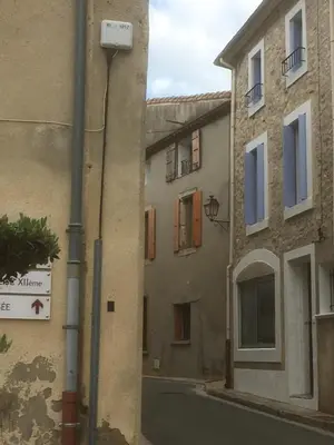 an alley between two buildings in a city at appartement de la callade in Peyriac-de-Mer