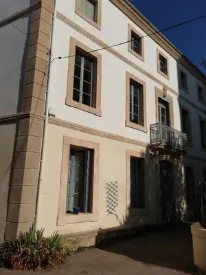 a white building with windows and a balcony at Les Colonnades in Moussan