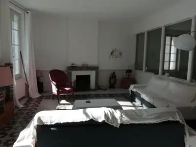 a living room with a couch and a chair at Les Colonnades in Moussan