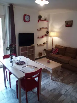 a living room with a table and a couch at Charmant studio centre ville Mirepoix in Mirepoix