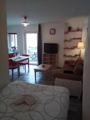 a living room with a couch and a table at Charmant studio centre ville Mirepoix in Mirepoix