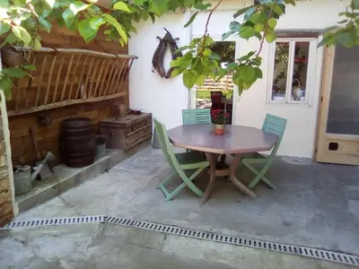 a wooden table and chairs on a patio at Charmant studio centre ville Mirepoix in Mirepoix