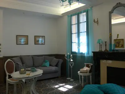 a living room with a couch and a fireplace at Maison d'hôte la Tourette in Cucugnan