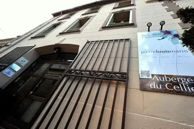 a building with a sign on the side of it at Auberge du Cellier in Montner