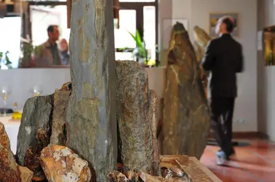 a person standing in front of a sculpture in a room at Auberge du Cellier in Montner