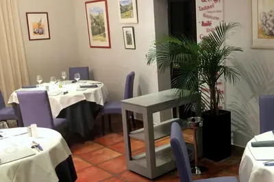 a dining room with two tables and a potted plant at Auberge du Cellier in Montner