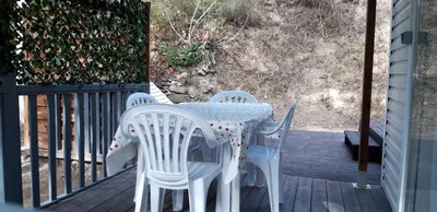 a table and chairs sitting on a deck at Camping la Source in Sournia