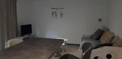 a living room with a table and a couch at Camping la Source in Sournia
