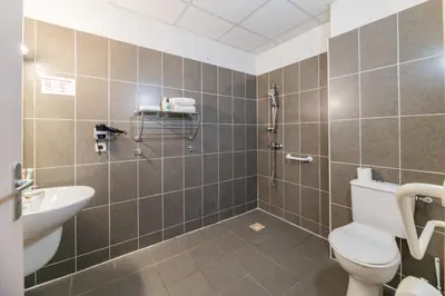 a bathroom with a shower and a toilet and a sink at Cerise Carcassonne Sud in Carcassonne