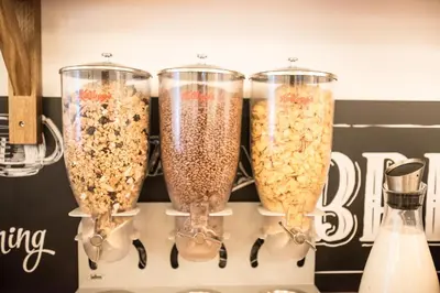 four glass vases filled with oatmeal on a shelf at Cerise Carcassonne Sud in Carcassonne