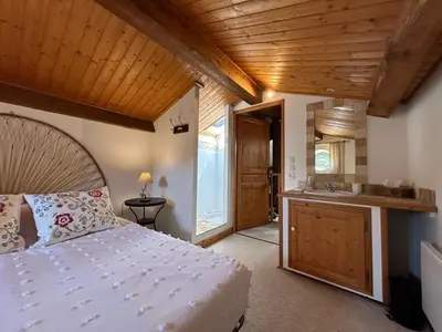 a bedroom with a large bed with two lamps at Gîtes du Vieux Tilleul, l'Ecurie. in Marseillette