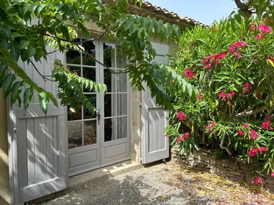 a view of a field through the trees at Gîtes du Vieux Tilleul, l'Ecurie. in Marseillette