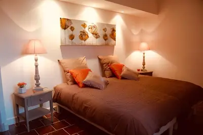 a bedroom with a white bed and a window at Gîtes du Vieux Tilleul, l'Ecurie. in Marseillette