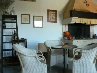 a kitchen with a table and chairs and a fireplace at Chambres d'hôtes Domaine de Beaupré in Narbonne