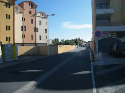 a flock of birds flying over a town with a castle at Perle méditerranéenne au coeur du port de Gruissan in Gruissan
