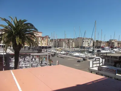 a large swimming pool in front of some buildings at Perle méditerranéenne au coeur du port de Gruissan in Gruissan
