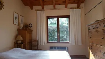 a bedroom with a large bed and a window at Le Cers in Ribaute