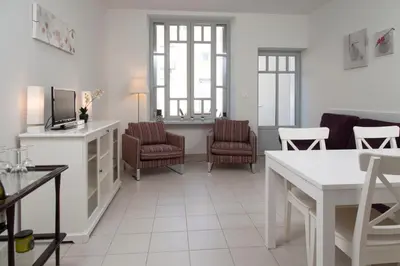 a living room with chairs and a couch and a table at La Terrasse de Jules in Carcassonne