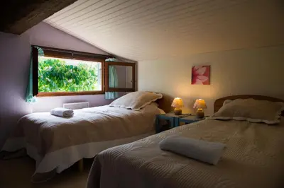 a bedroom with two beds and a window at Nature's Pace Holidays in Montmaur