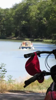 a bike handle bar with a boat in the water at Nature's Pace Holidays in Montmaur