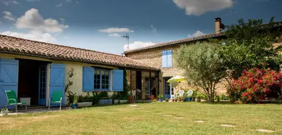 a house with a yard with chairs and a tree at Nature's Pace Holidays in Montmaur
