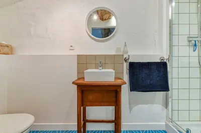 a bathroom with a sink and a toilet and a shower at La Calade in Montouliers