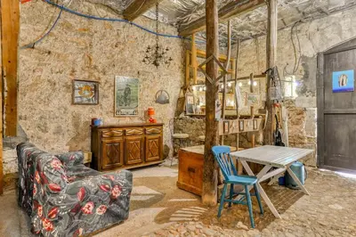 a living room with a couch and a table at La Calade in Montouliers