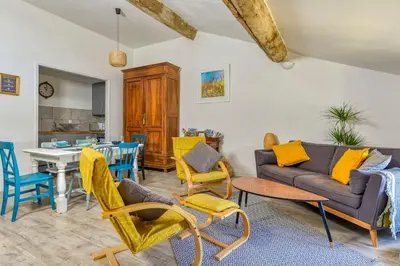 a living room with a couch and chairs and a table at La Calade in Montouliers