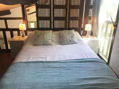 a bedroom with a large bed with two lamps at Hameau de Montcabirol - Pyrénées in Mirepoix