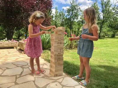 two young girls playing with a jenglé at Hameau de Montcabirol - Pyrénées in Mirepoix