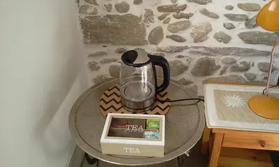 a table with a blender and a box on it at Maison de ville au pied de la Montagne Noire in Mazamet