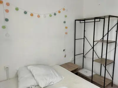 a bedroom with a bed and a shelf and balloons at T2 sur le port avec parking in Gruissan