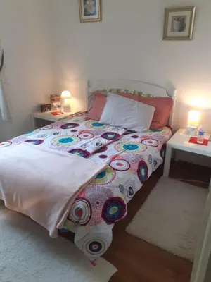 a bed with a comforter and pillows in a bedroom at chez Black and White in Les Martys