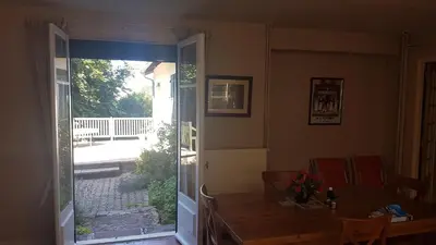 a room with a door open to a patio at chez Black and White in Les Martys