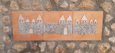 a drawing of a castle on a stone wall at Appartement Climatisé T3 Piscine et Parking in Pennautier