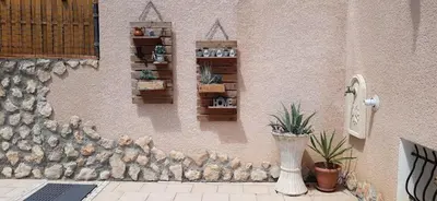 a wall with a bunch of plants on it at Appartement Climatisé T3 Piscine et Parking in Pennautier