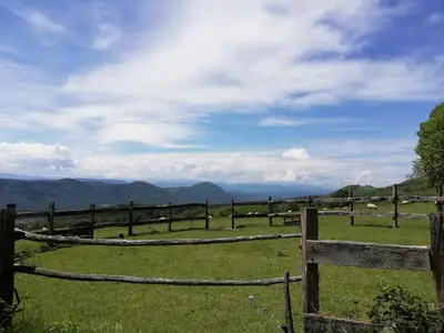 a fence in a field with sheep in the mountains at Domaine des Goudis in Bouisse