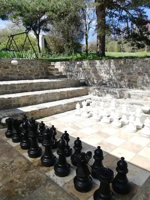 a chess set on a chessboard in a park at Domaine des Goudis in Bouisse