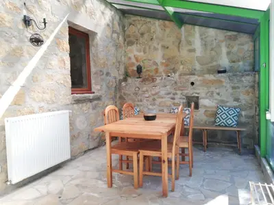 a dining room with a wooden table and chairs at Domaine des Goudis in Bouisse