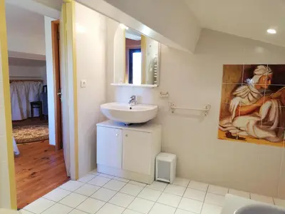 a bathroom with a sink and a painting on the wall at Domaine des Goudis in Bouisse