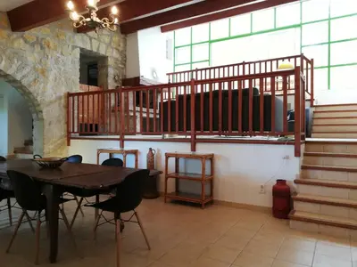 a dining room with a table and a staircase at Domaine des Goudis in Bouisse