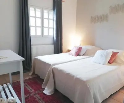 two beds in a room with a window at Domaine des Goudis in Bouisse
