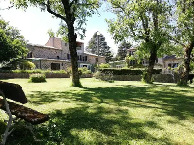 a park with a bench in front of a house at Domaine des Goudis in Bouisse
